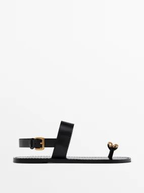 Flat sandals with metallic embellishment