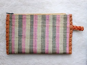 pink, green, and cream striped raffia woven clutch with leather trim